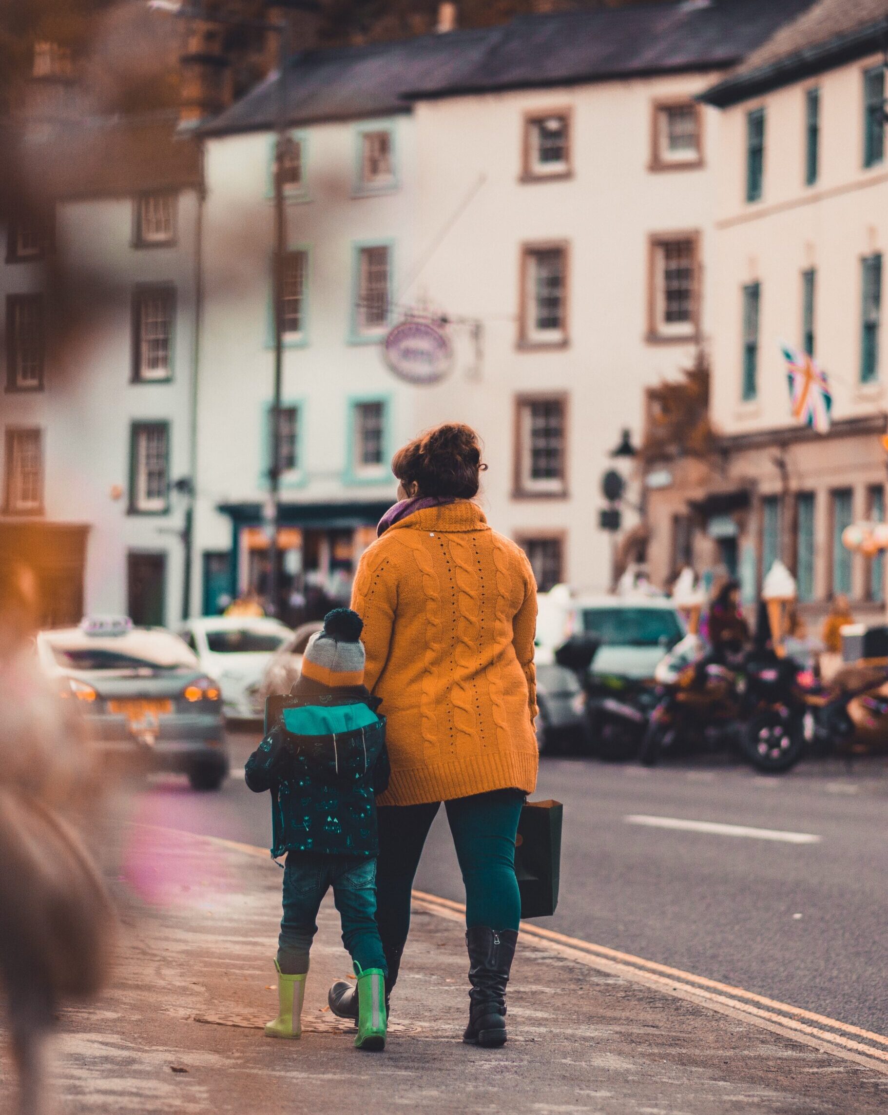 A mother and son walk down a Cornish street in the winter time